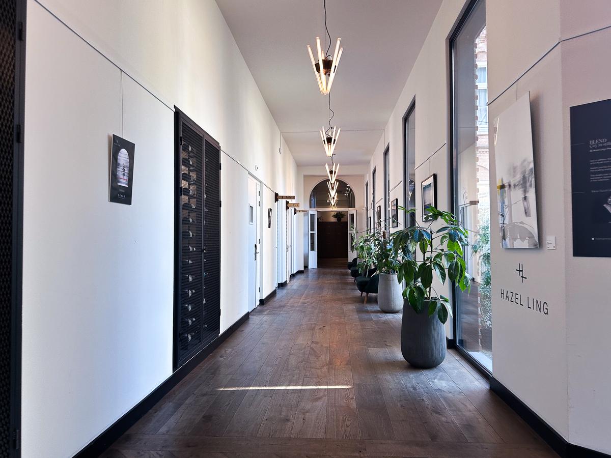 Modern hotel interior with stylish hallway, artistic lighting, and wooden floors in Hotel Arena Amsterdam
