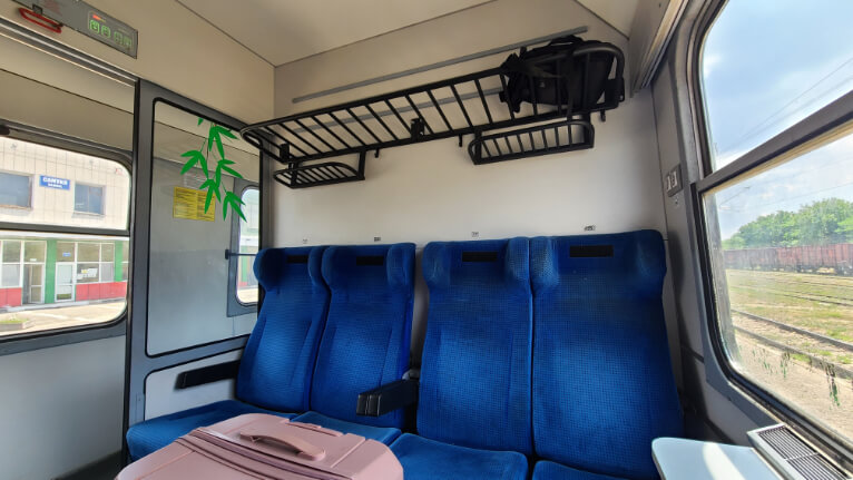 A row of 4 royal blue chairs on an old train in Bulgaria