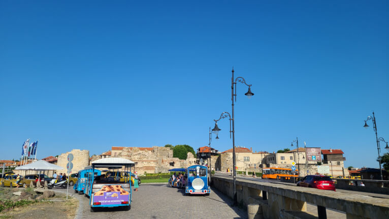 Two Nessebar Tourist trains parked outside the walls of the old city.