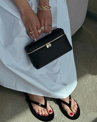 Woman holding a black handbag.