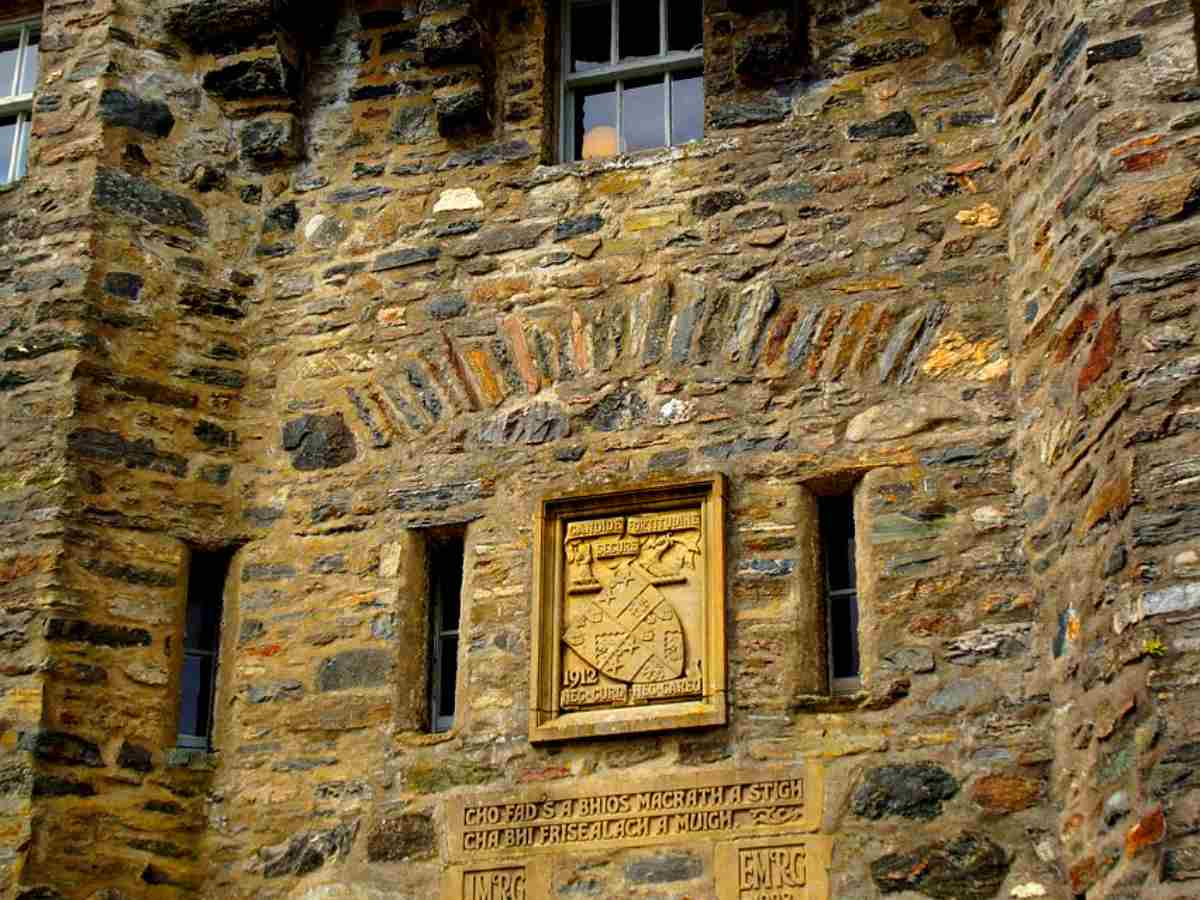 medieval stone wall above the entrance door of the castle