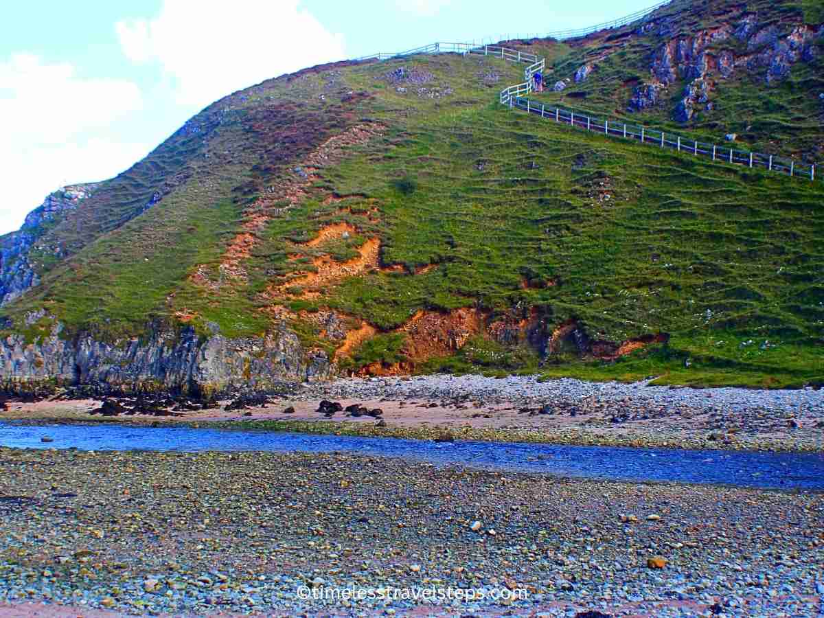 steep steps along the cliff leading to the cavern