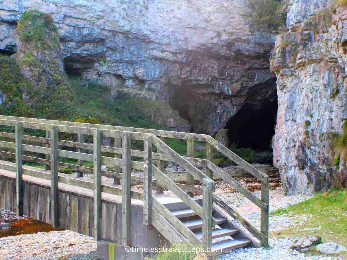 a closer view of the wooden bridge and the opening to the cave