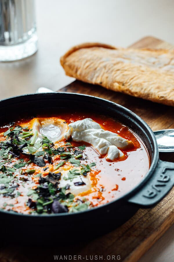 A cast iron pan of shakshuka, a popular Georgian breakfast dish at a cafe in Kazbegi.