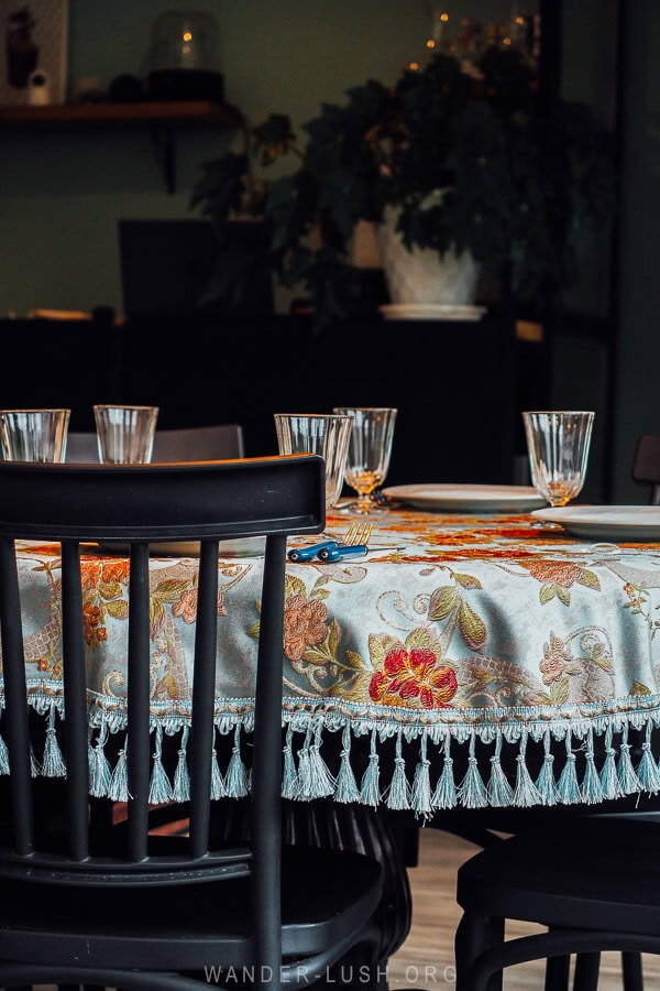 A table with a silk cloth set for dinner at a small restaurant in Stepantsminda.