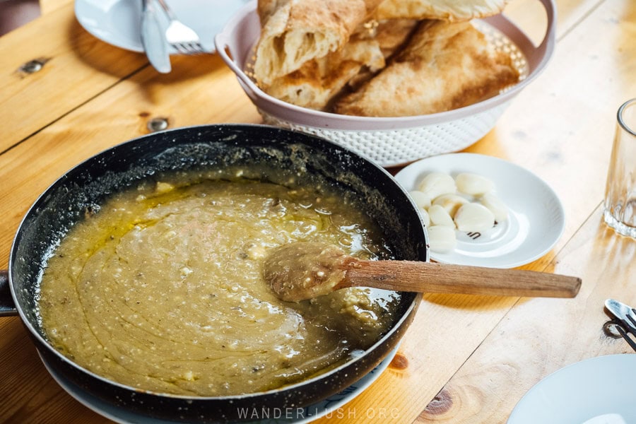 Kharchoerbo, a dish of melted cheese served in a frying pan with a wooden spoon at a restaurant in Pshavi.