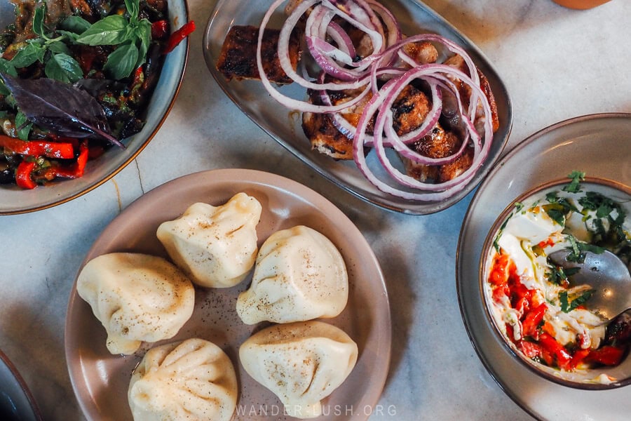 Plates of Georgian cuisine mtsvadi, ajapsandali and khinkali at Kaklebi restaurant on the Tskneti Highway.