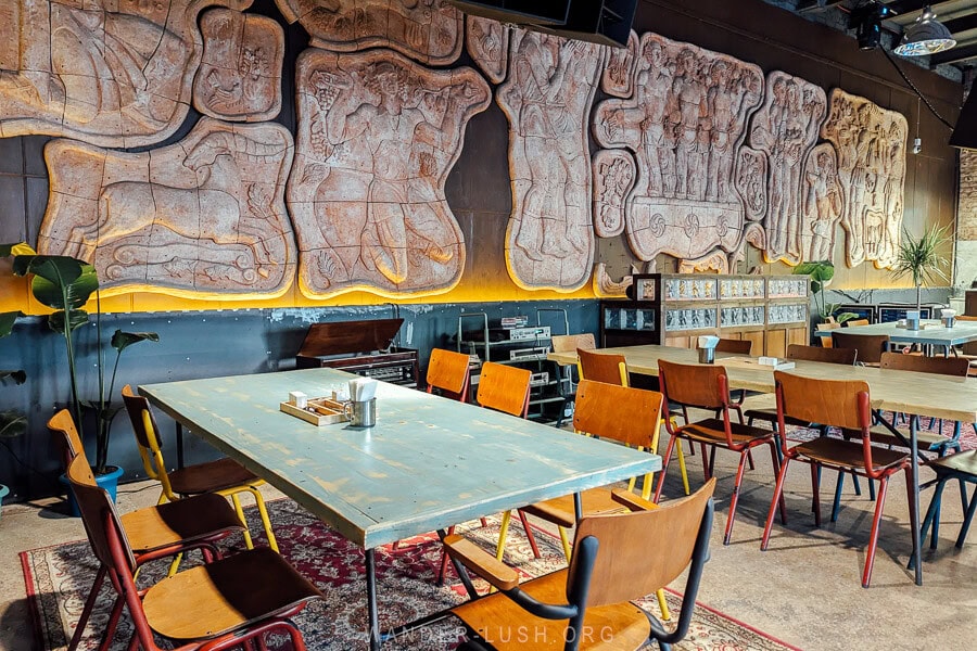 Sasadilo Zeche, a Soviet-themed restaurant in Tbilisi with bas-relief wall sculptures and Caucasian carpets on the floor.