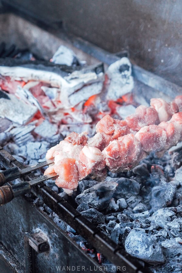 Grilling pork over charcoal at Big Boar Tbilisi.