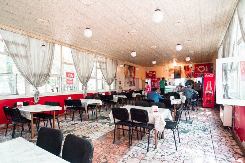 Coca-Cola Diner bottler's factory, a bright dining room filled with tables in Tbilisi.