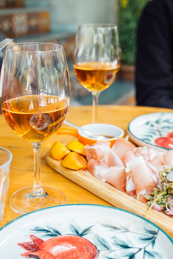 Two glasses of amber wine and a board of Racha ham at G.Vino in Tbilisi.