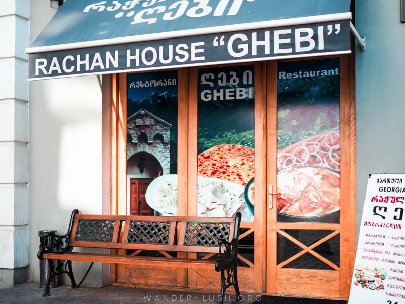 The exterior of a restaurant with pictures of food on the front windows.