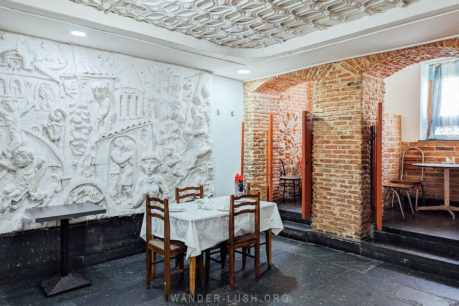 Mapshalia, a basement restaurant in Tbilisi with a Soviet relief sculpture and private dining nooks.