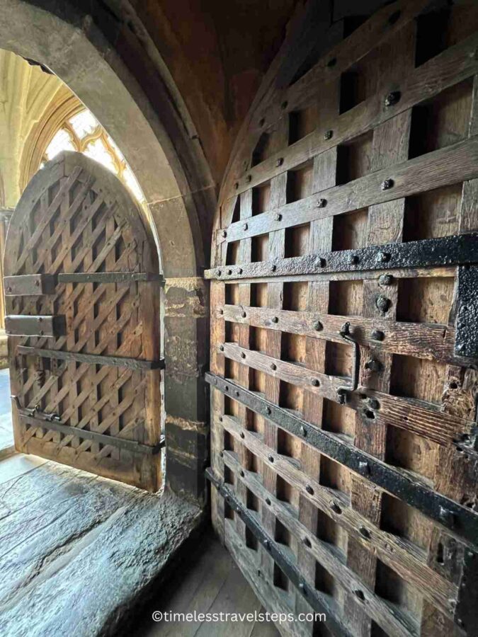 Image of the sturdy door to the Pyx Chamber at Westminster Abbey. This ancient oak door, dating back to the 11th century, features robust iron hinges and has withstood the test of time, reflecting the historical significance and enduring craftsmanship of the period.
