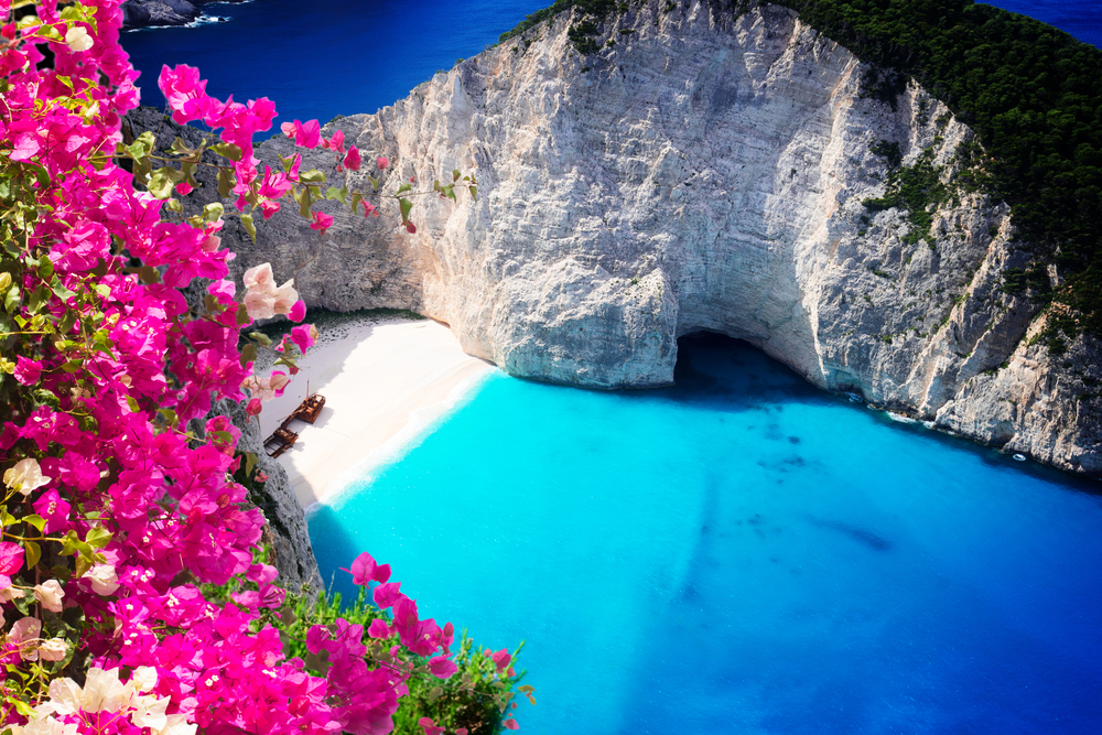 Navagio beach, shipwreck beach, famous overhead summer lanscape of Zakinthos island, Greece with flowers