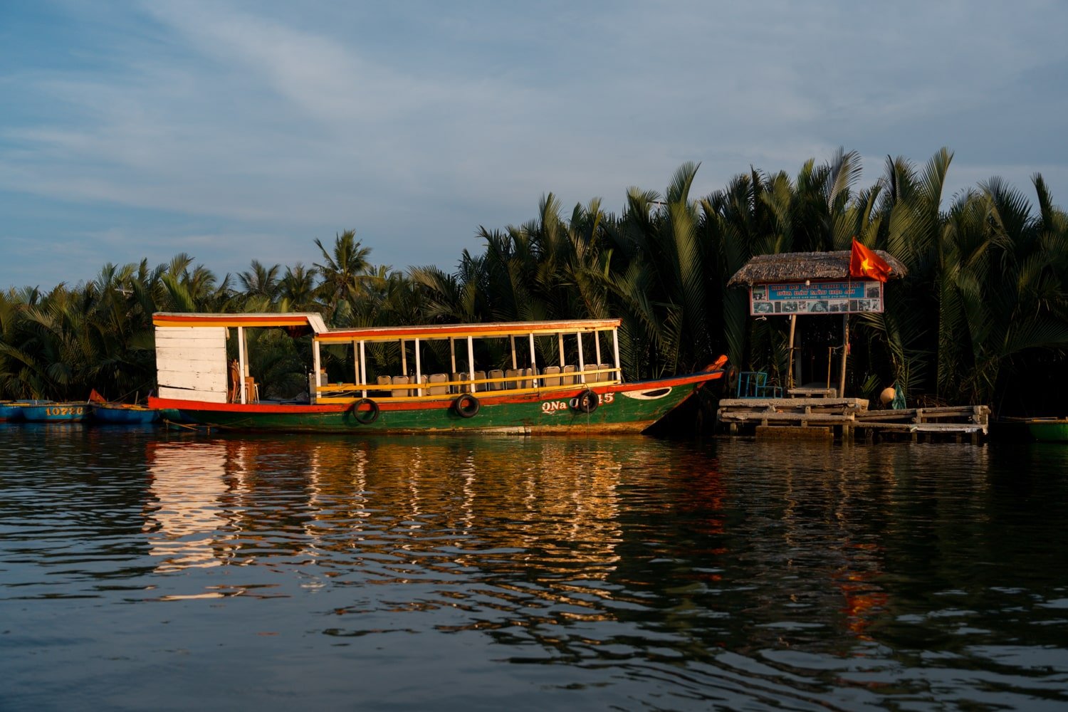 Boat on the Thu Bon River at sunset in Hoi An, Vietnam.