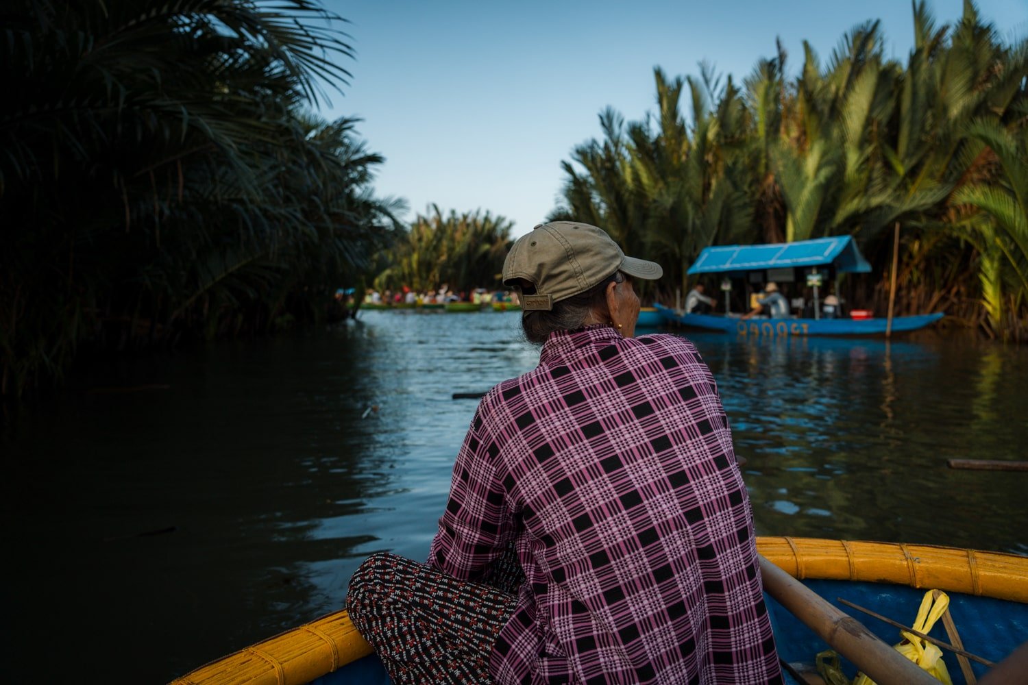 A Vietnamese boat guide rowing through the Bay Mau coconut forest grove on the Thu Bon River near Hoi An, Vietnam.