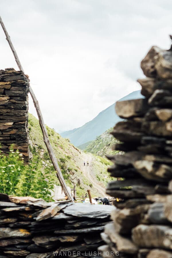 Two hikers on a road into the mountains in Khevsureti.