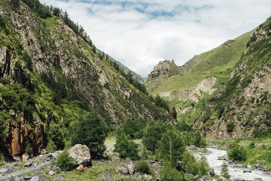 View of Mutso Fortress on the hillside between mountains in a river valley in Khevsureti.