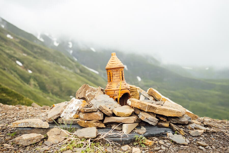 A shrine surrounded by rock marks the highest point of the Datvisjvari Pass road from Tbilisi to Khevsureti.