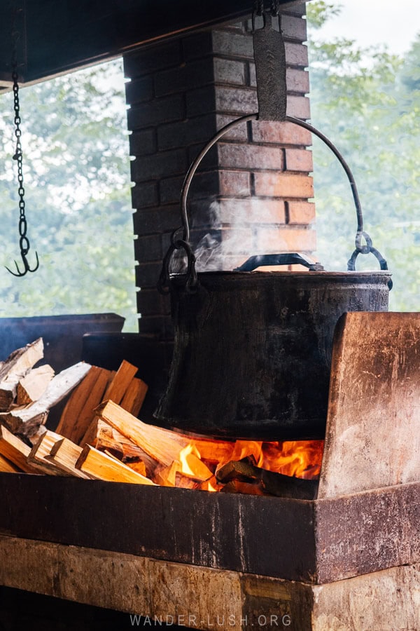 A giant black pot of boiling water over an open fire at a restaurant in Pshavi, Georgia.