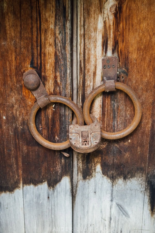 An old wooden door with a rusty lock.