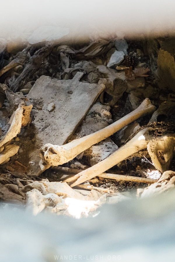 A pile of bones and wooden fragments inside the Anatori Crypts in Khevsureti.