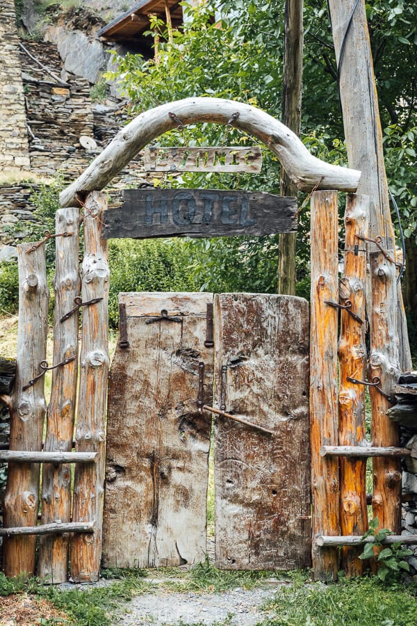 The gate to Ethnic Hostel in Shatili, Georgia, crafted from wood.