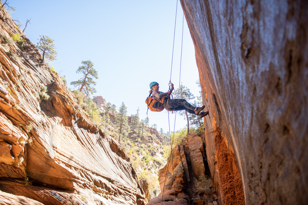 woman rappelling and rock climbing in Zion national park