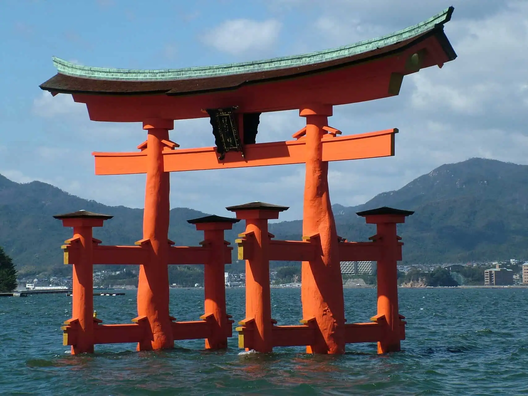 Red tori gate in the water in Japan by Very Tasty World