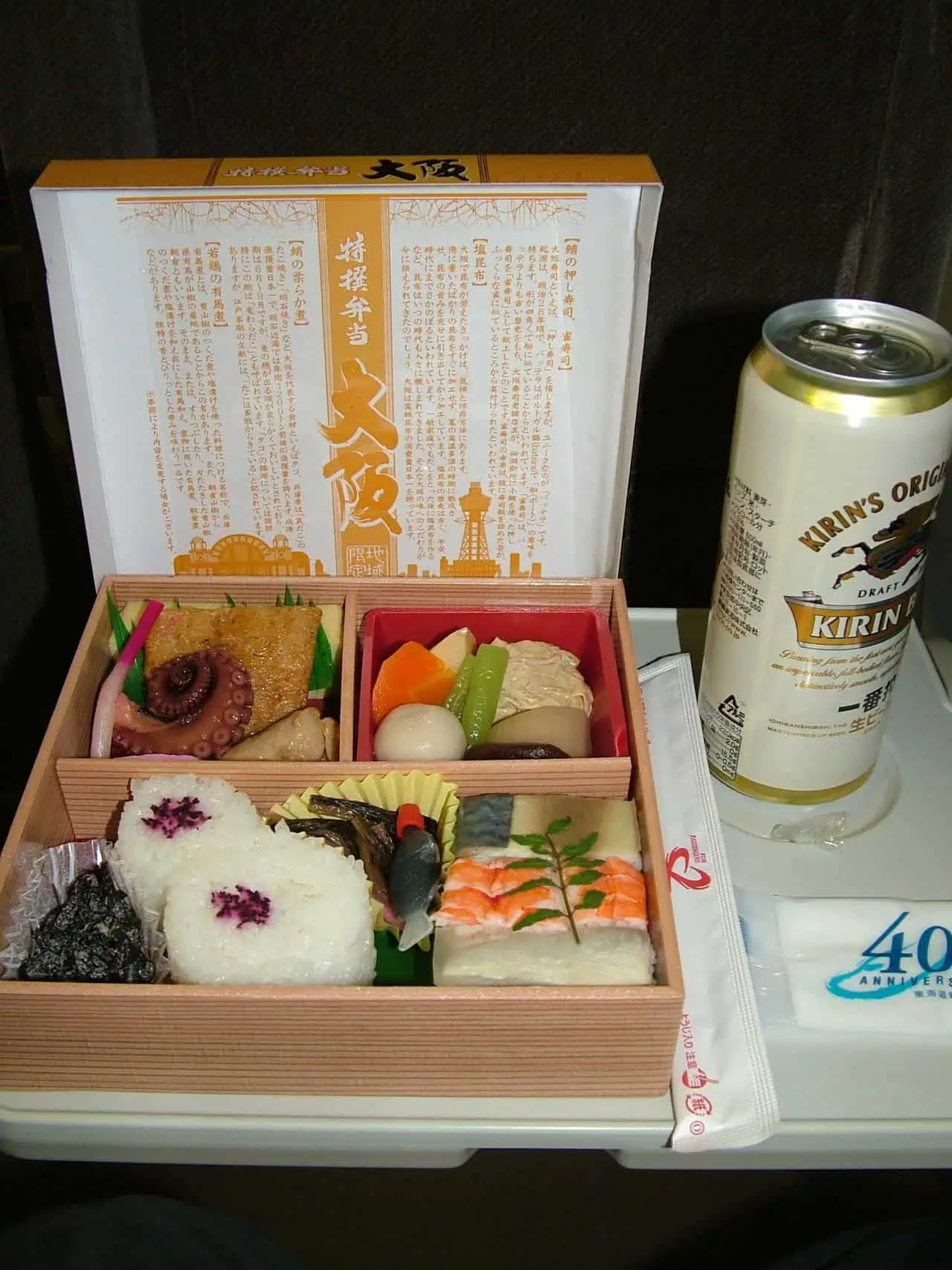 Bento box and can of beer on a Japanese train by Very Tasty World