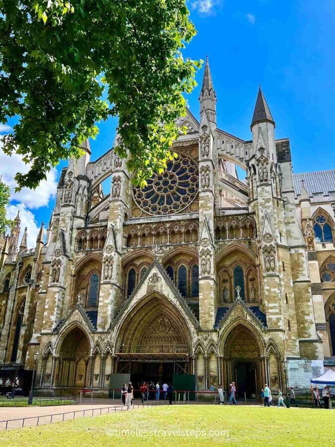 Image of the North Door entrance at Westminster Abbey, showcasing intricate design details and elaborate carvings. The door features ornate Gothic elements, including detailed stonework and historical motifs, exemplifying the architectural grandeur of the Abbey
