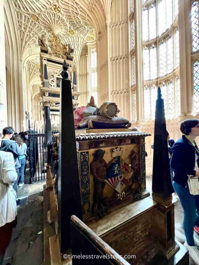 The tomb of Mary, Queen of Scots in Westminster Abbey, elevated on a platform, featuring intricate carvings and elaborate decorations, highlighting the high regard held by her son, King James I, and her historical significance.
