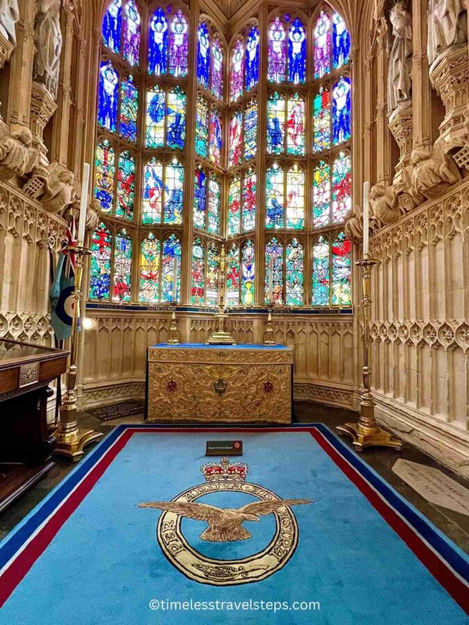 The Royal Air Force Chapel in Westminster Abbey, featuring the distinctive blue colour of the RAF, a beautiful stained glass window that casts colourful light across the chapel, and an elegant altar, creating a serene and reverent atmosphere.
