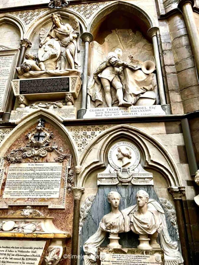 The wall of Poet's Corner in Westminster Abbey is adorned with memorial plaques and busts—sculpted representations of heads, shoulders, and chests—dedicated to famous poets and writers such as William Shakespeare, Jane Austen, Robert Southey, George Handel, and others. These features include intricate inscriptions and carvings that honour their contributions to literature.
