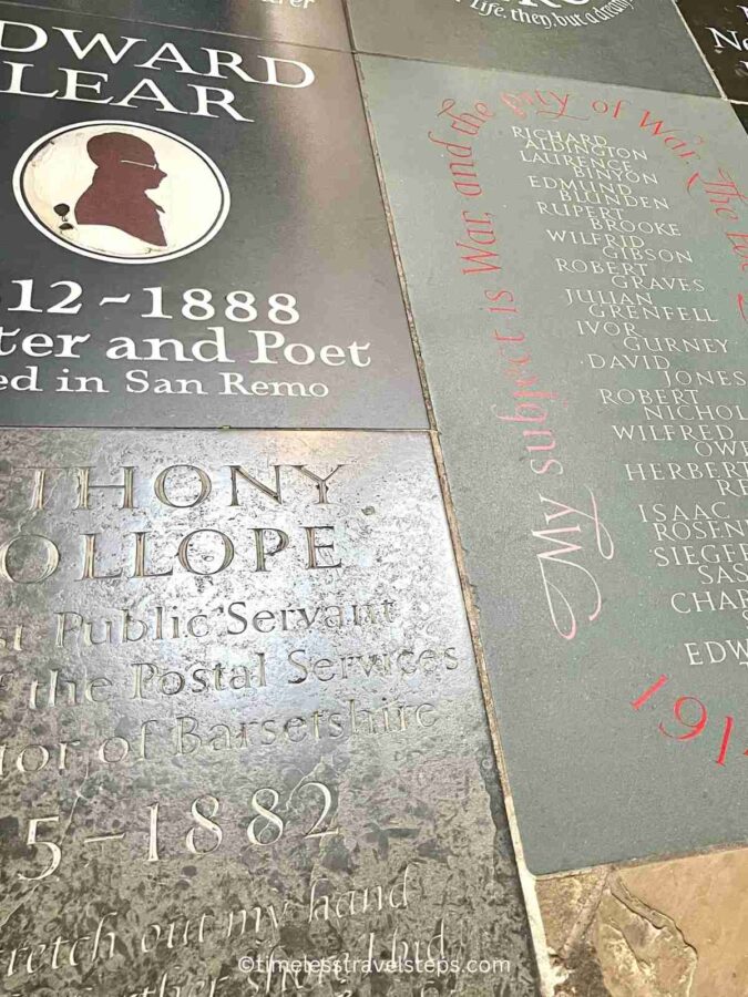 The floor of Poet's Corner in Westminster Abbey, adorned with memorial stones and plaques dedicated to famous poets and writers such as Lewis Carroll, Edward Lear, and Lord Byron, featuring intricate inscriptions and carvings that commemorate their contributions to literature.
