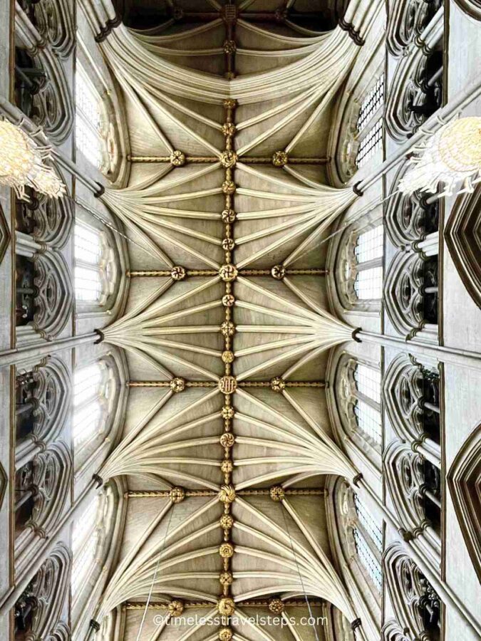 showcasing the intricate ribbed vaulting and detailed Gothic stonework. The design features ornate patterns and stunning craftsmanship, contributing to the majestic and awe-inspiring atmosphere of the Abbey.
