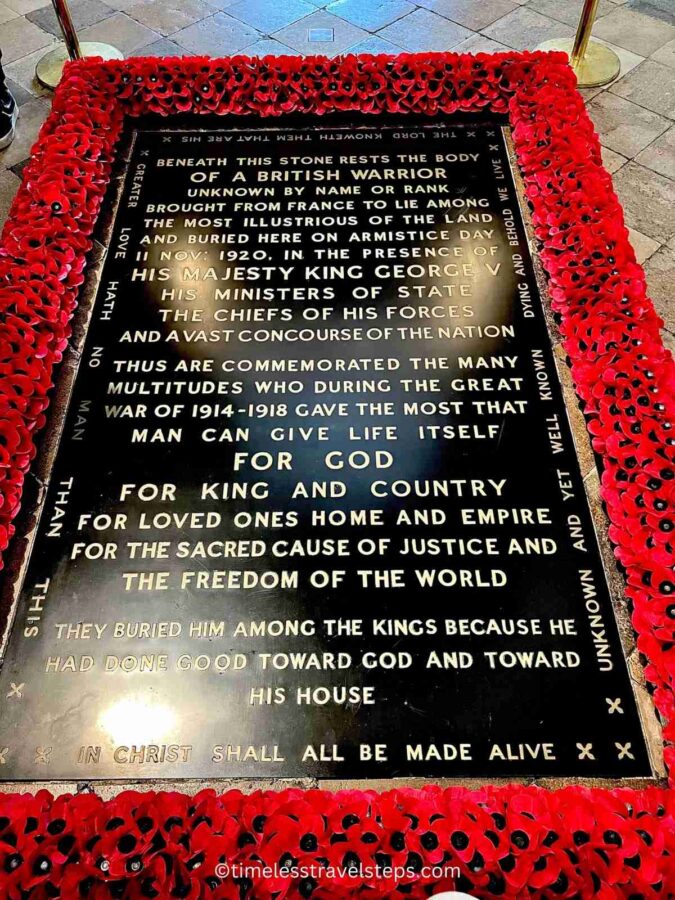 Image of the Tomb of the Unknown Soldier at Westminster Abbey, marked by a simple yet poignant inscription and surrounded by vibrant red poppies. The tomb honours unidentified soldiers who died in war, symbolizing the sacrifice of many.
