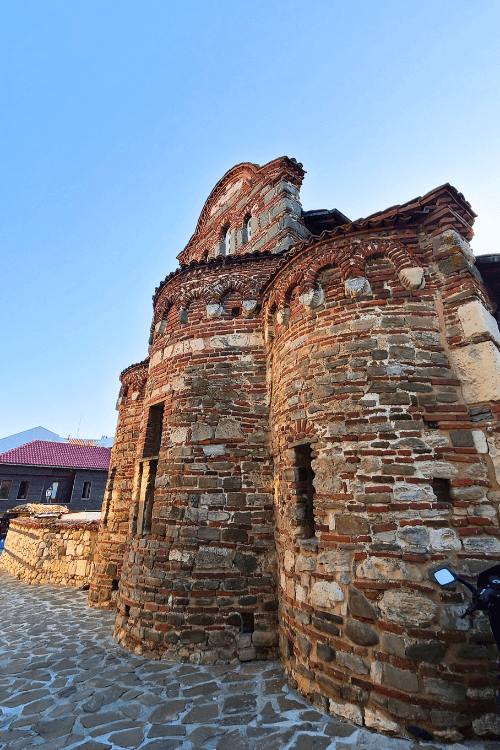 A dramatic wide angle shot of the Church of St Stephen in Nessebar. The 10th century church still stands mostly intact, with three beautiful rounded naves in the front.