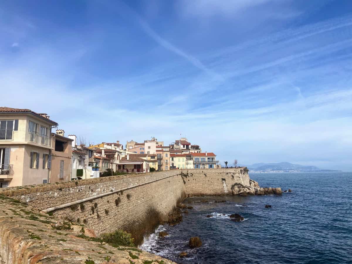 View of Antibes along the coastline showing off the ocean, city walls and old buildings