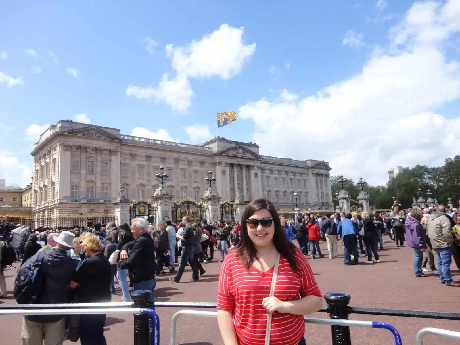 Riana posing in front of Buckingham Palace in London, England