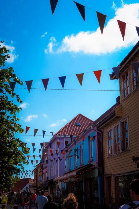 Colorful Fargegaten street with vibrant buildings and festive bunting in Stavanger, Norway