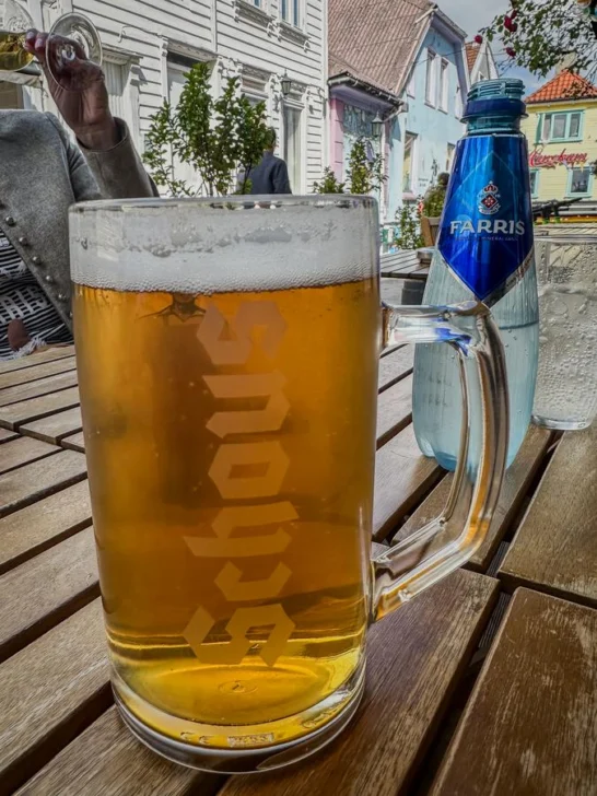 Enjoying Schous Pilsner at an outdoor café in Norway, local beer, Norwegian beer, beer tasting