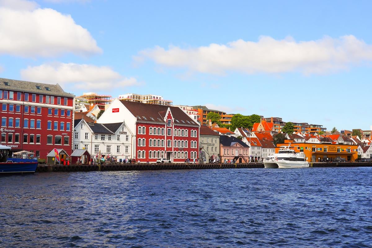 Colorful buildings along Stavanger waterfront, Norway, with blue sky and calm sea