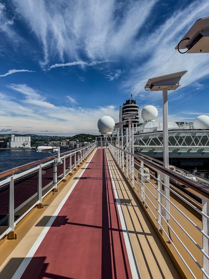 Jogging track on Holland America cruise ship with scenic ocean view and wellness activities onboard.