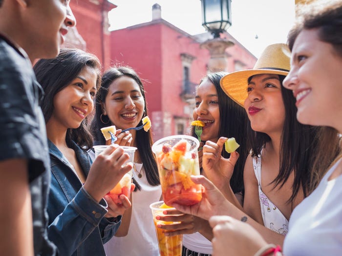 a group of people eating fresh fruit in Mexico
