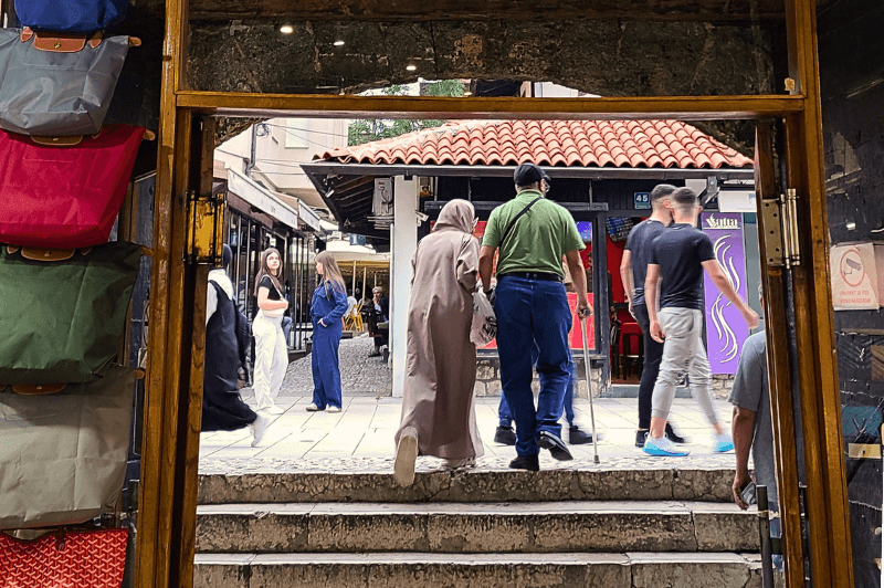 A couple leans on each other as they exit the old bazaar in Sarajevo.