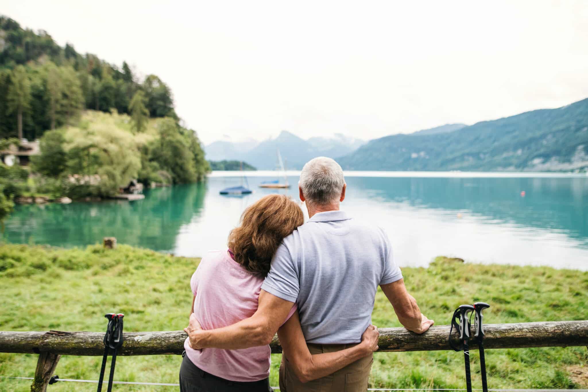 A senior couple facing a beautiful view while traveling.