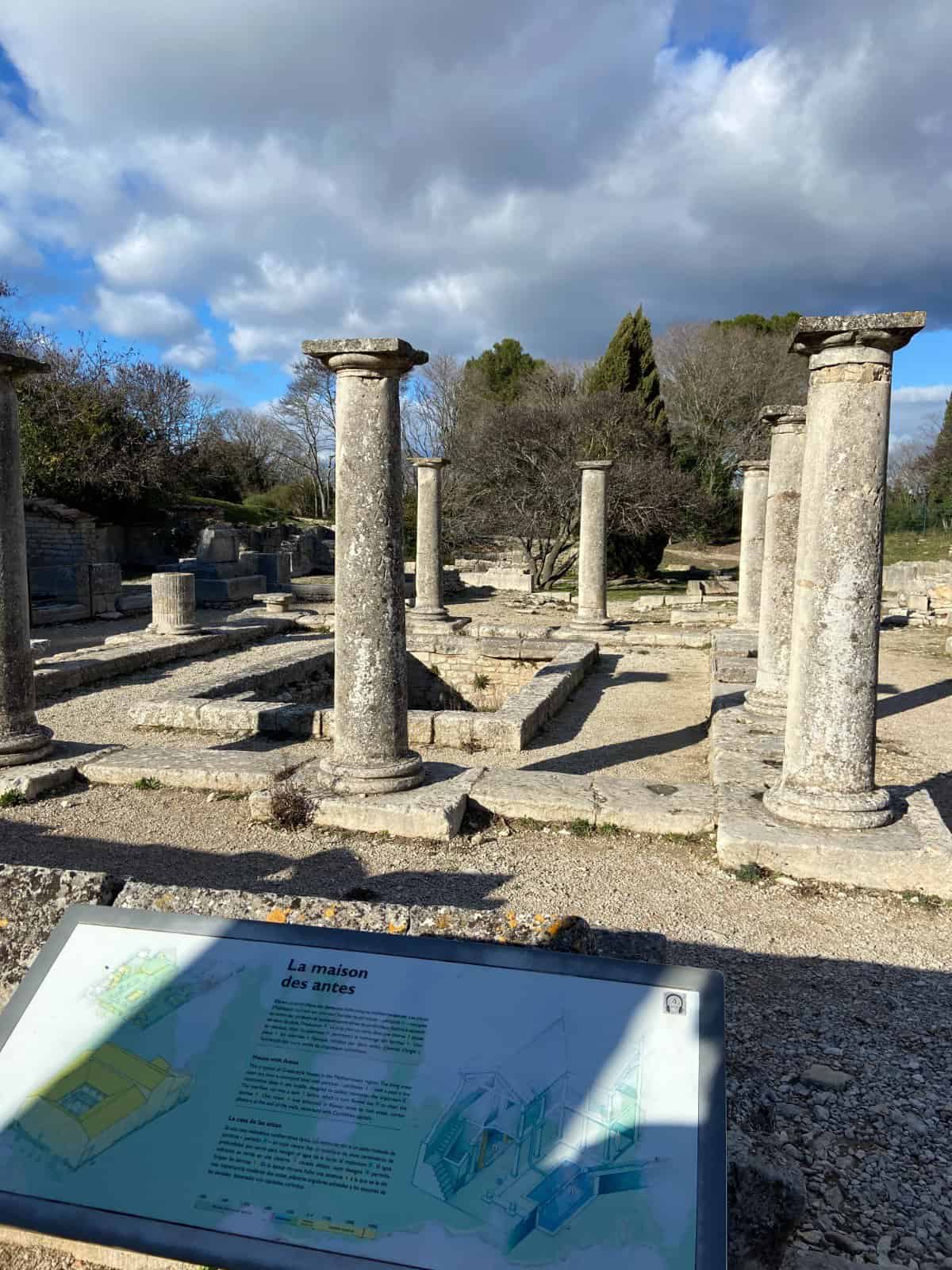 Columns with an info plaque in front of them in Glanum