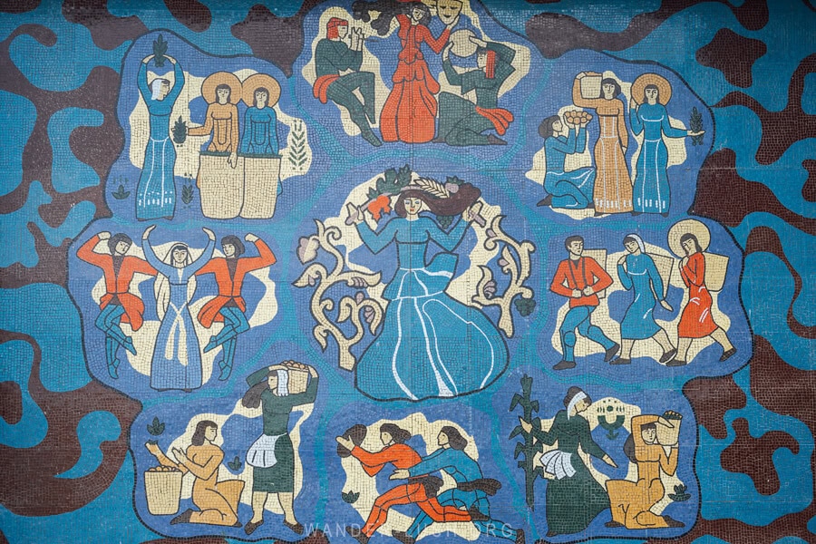 A beautiful blue mosaic depicting different Soviet industries, sports and traditional Georgian dance in Chaisubani, Guria.